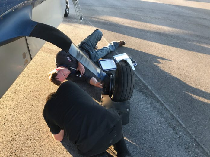 InspectingCaravanWheel